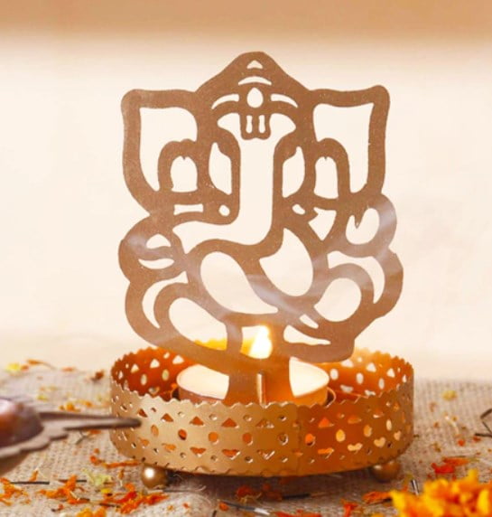 Golden Finish Metal Lord Ganesha Tealight Holder by Anasa Rs.49 - Pepperfry
